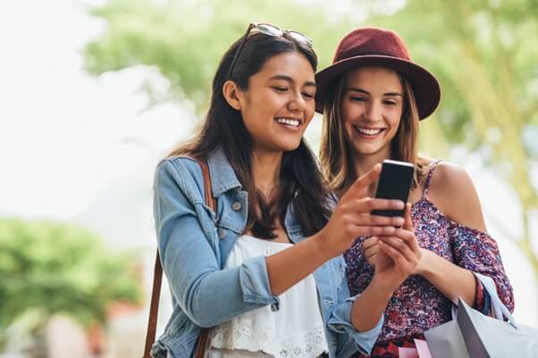 Women searching for second hand items on the phone