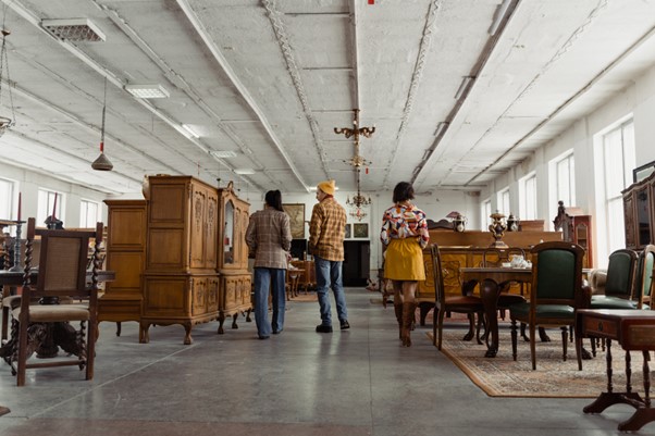 Friends exploring in a vintage and second hand store.